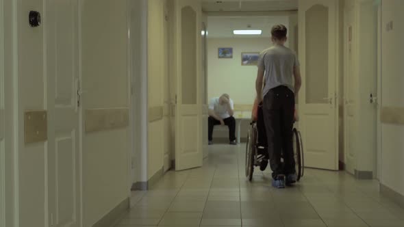 Young Guy Moves Along the Corridor