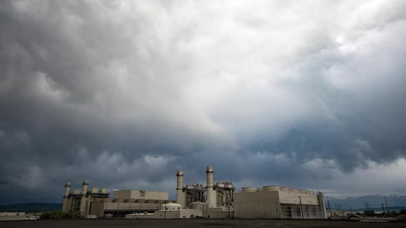 Moody clouds moving over factory on stormy day