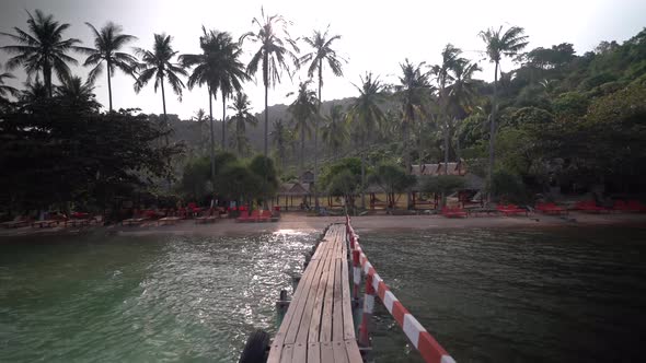 Steadicam walking along pier on an island in southeast asia.