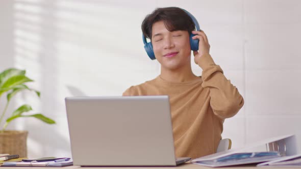 Entrepreneur handsome business asian man wear casual shirt and earphone listen having fun with music