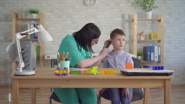 Young Doctor Pediatrician with Small Boy