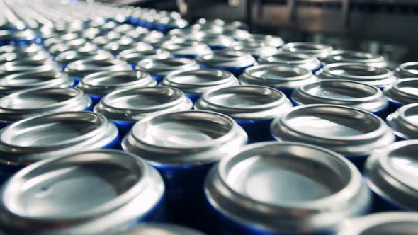 Many Cans with Beer Moving on a Conveyor, Close Up.