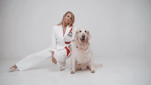 White Golden Retriever Puppy with Owner Girl Posing to Camera on White Background