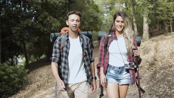 Couple of Hikers Carrying Camping Backpacks