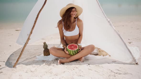 Woman on the Tropical Beach Eating Watermelon