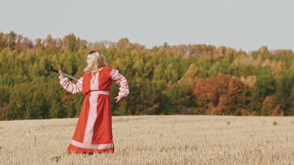 Feisty Woman in Red Dress Training on the Field - Trains with a Curved Sword