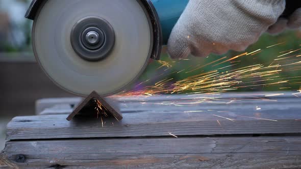 Worker in Gloves Use Angle Grinder