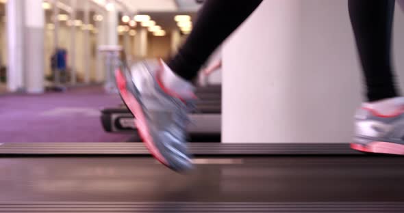 Super Fit Woman Running on the Treadmill