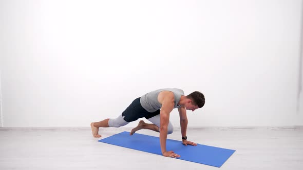 Muscular Athlete Doing Mountain Climber Running Plank Exercise on Fitness Mat Sport Routine