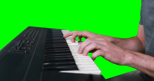 Mid section of musician playing electronic piano