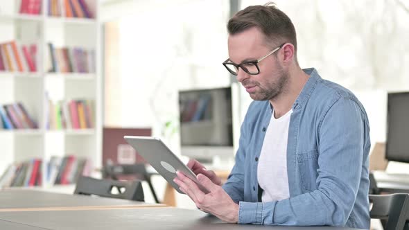 Young Man Using Tablet at Work