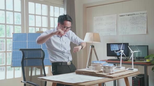 Side View Of Asian Man Being Happy Succeed Building A Model Of Small House With Solar Panel