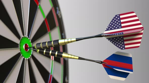 Flags of the USA and Russia on Darts Hitting Bullseye