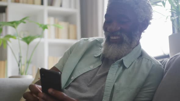 Video of african american senior man using smartphone