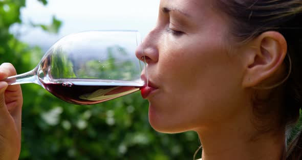 Close up of woman drinking a red wine