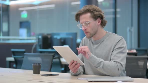 Successful Young Businessman Celebrating on Tablet