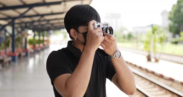 Man taking a photo at train station