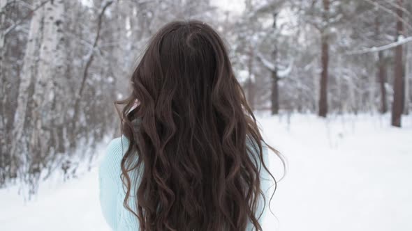 Stylish Young Woman Walking Towards Winter Forest