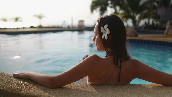 Caucasian Woman Relaxing in Resort Swimming Pool