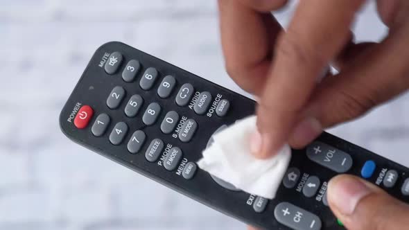 Cleaning Tv Remote Control with an Antibacterial Fabric Tissue..