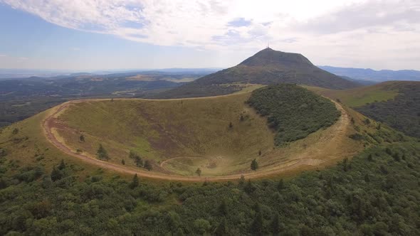 Aerial travel drone view of the Puy de Dome, lava dome volcano in France.