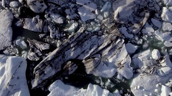 Aerial view of Jokulsarlon glacier lagoon with iceberg floating and mountains