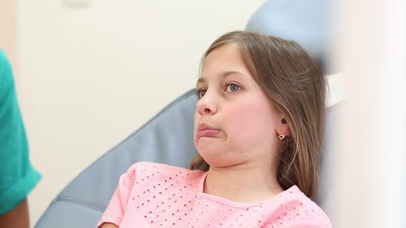 Close up of a girl making faces and laughing while having a dental checkup