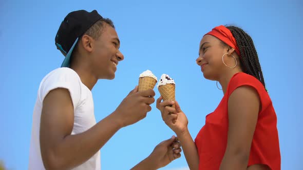 Caring Boyfriend Wiping Nose of Cute Girlfriend Eating Big Ice-Cream, Proximity