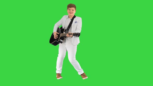 Boy Moves Like Elvis with Guitar on a Green Screen Chroma Key