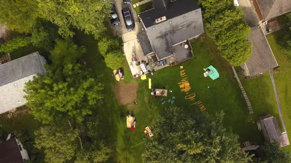 Aerial view of construction workers building in a house's backyard.
