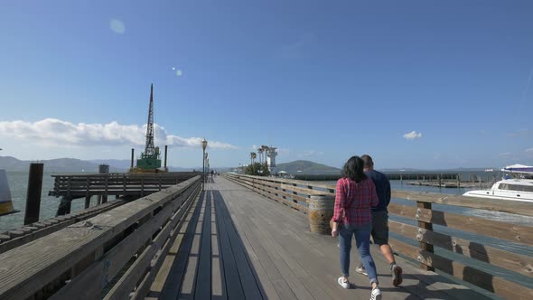 Couple walking on a pier