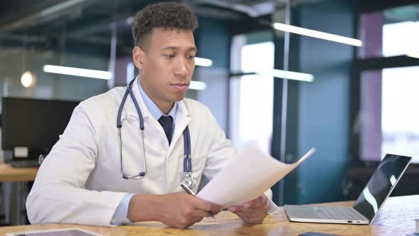 Cheerful Young Male Doctor Giving Documents To Client 