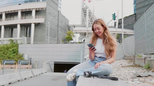 Slow motion young woman outdoor using smartphone