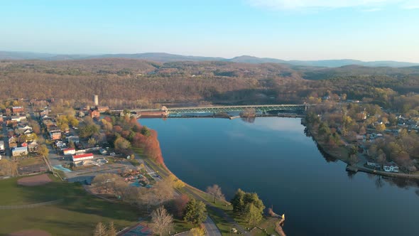 Aerial pan view over a blue lake in Greenfield, Massachusetts in the New England area. You can see a