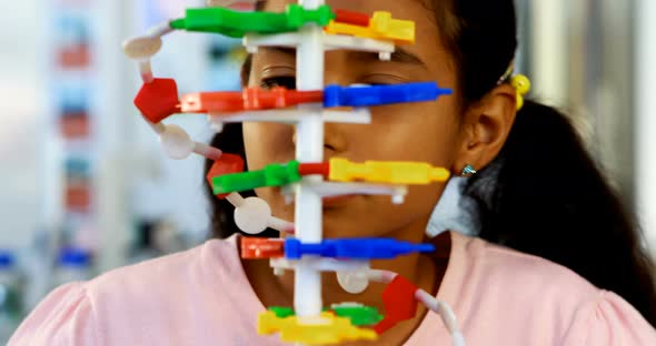 Schoolkid experimenting molecule model in laboratory 4k