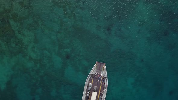 Aerial view above ferry boat with cars in the mediterranean sea, Kosta, Greece.