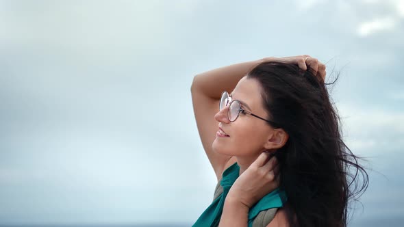 Pleasant Happy Woman Relaxing Playing Hair at Sky and Sea