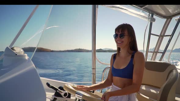 Cheerful Brunette Young Woman Riding White Pleasure Yacht Spending Sunny Day at Sea