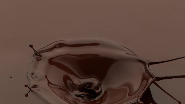 Super Slow Motion Detail Shot of Melted Chocolate Crown Splash at 1000 Fps