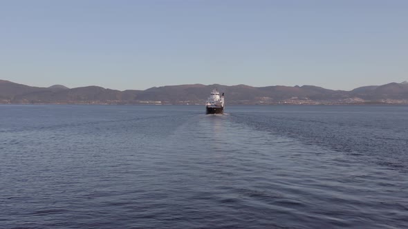 Norwegian Ferry Service Crossing a Fjord Carrying Passengers and Vehicles