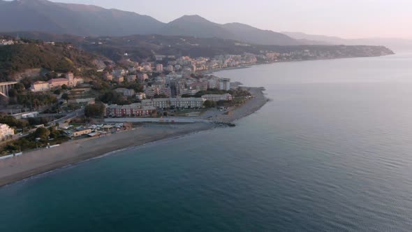 drone shot of a beautiful spring sunrise at a small coast city of west-italy in varazze