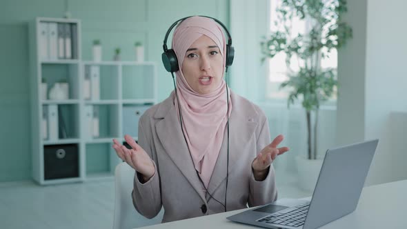 Muslim Islamic Girl Wearing Hijab Chatting with Microphone and Headphones Working in Call Center