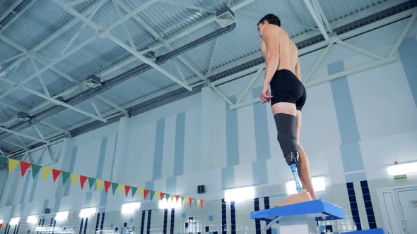 A Male with a Prosthetic Leg Is Preparing To Swim in a Pool