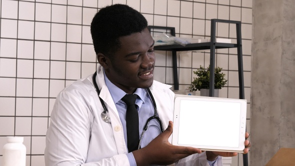 Smiling Doctor Presenting Product on A Tablet Computer