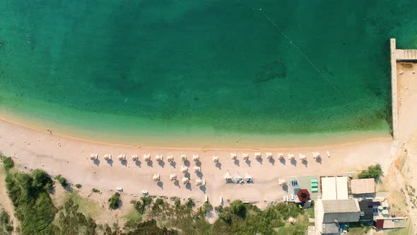Aerial view of umbrellas at Vela luka beach, Baska, Croatia.