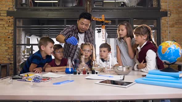 Chemistry Teacher Teaches Young Students to do Chemical Reaction Experiments