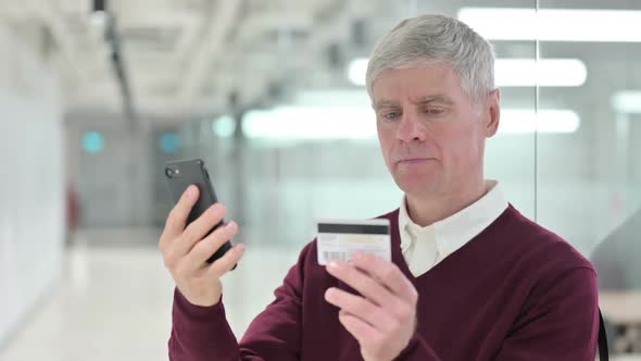 Middle Aged Man Making Online Payment on Smartphone