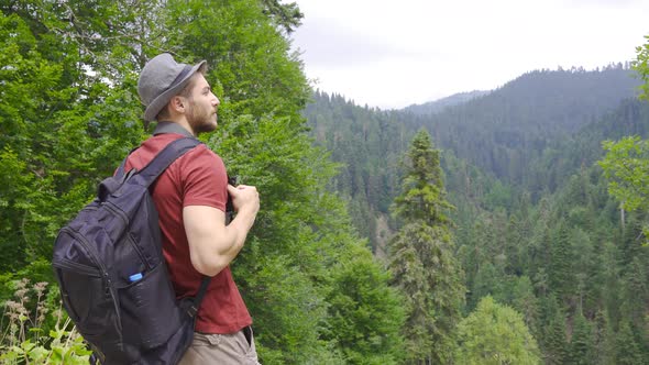 Man watching the valley in the forest.