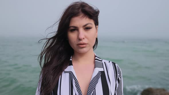 Portrait of Happy Young Woman Smiling at Sea