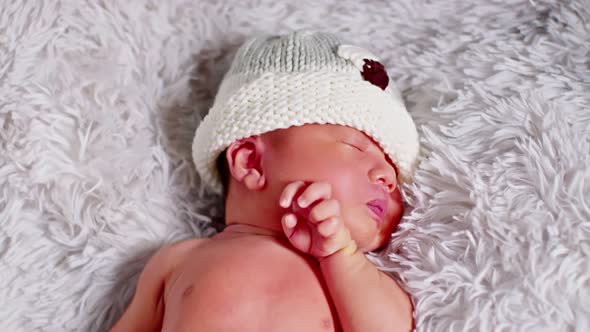 happy newborn baby weaing cute costume lying sleep on grey carpet